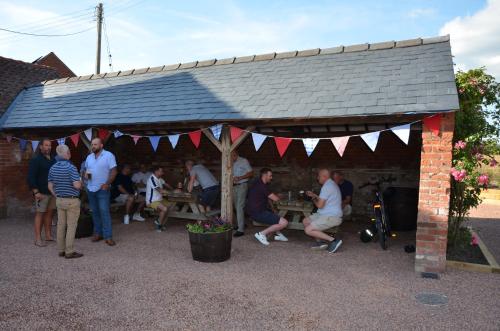a group of people sitting at tables under a tent at The Red Lion, Madley in Hereford