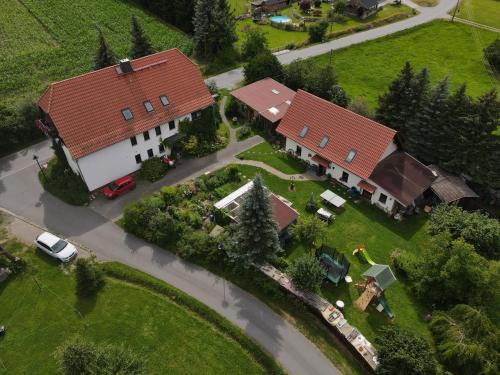 an overhead view of a large house with two red roofs at FeWo Spreequelle in Herrnhut