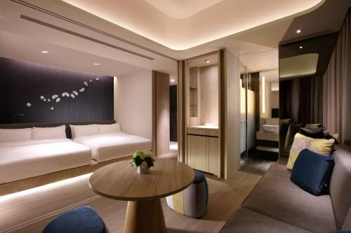 a living room with a couch and a table at 礁溪晶泉丰旅 Wellspring by Silks Jiaoxi in Jiaoxi