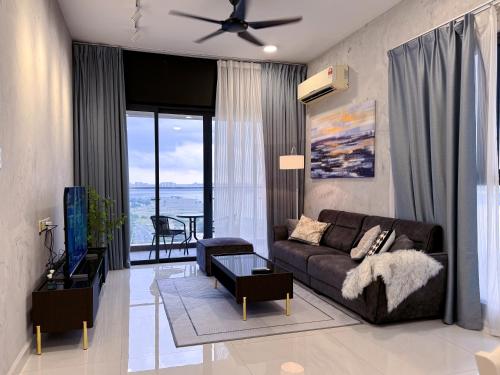 a living room with a couch and a table at Country Garden Danga Bay By Minshuku in Johor Bahru