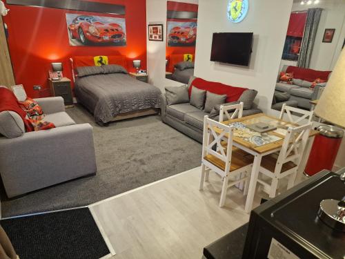 a living room with a bed a couch and a table at Joiners Arms - Studio Apartments in Market Drayton