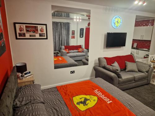 a living room with a bed and a couch at Joiners Arms - Studio Apartments in Market Drayton