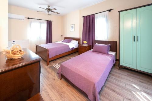 a hotel room with two beds and a dresser at Urla Köstem Müze Otel in Uzunkuyu