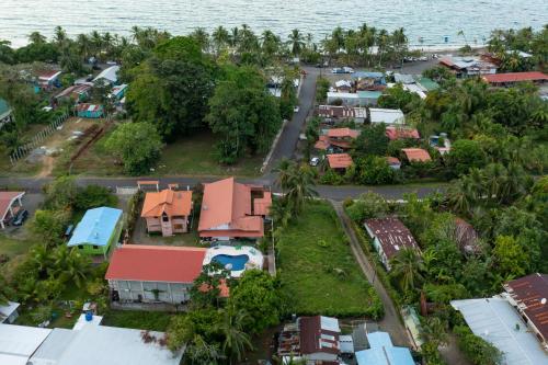 an aerial view of a village next to the ocean at Pangea Lodge with Shared Pool at the Heart of Manzanillo in Manzanillo