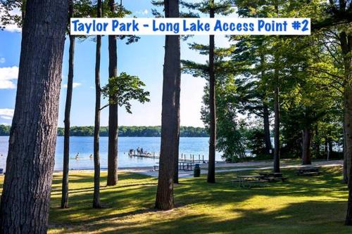 a park with a sign that reads long lake access point at Long Lake Escape, Modern 3 Bedroom, Lower Unit of Duplex Home, Minutes to Downtown Traverse in Traverse City