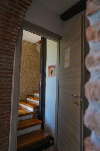 a hallway with stairs leading up to a room with a door at R-HOME Li Cuti in Catania