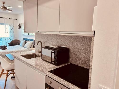 a kitchen with a counter top with a microwave at Lagos Marina view apt on main avenue near beaches in Lagos