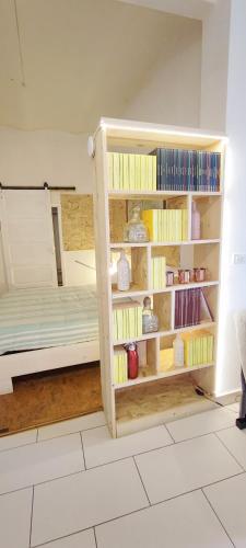 a room with a bed and a book shelf at Residenza BiblioSosta in Ventimiglia