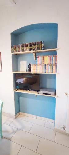 a book shelf filled with dvds and books at Residenza BiblioSosta in Ventimiglia
