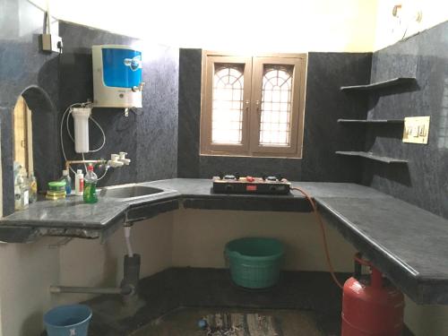 a kitchen with a sink and a counter top at jayaram Home in Chittoor