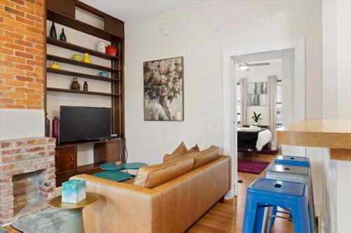 a living room with a couch and a tv at Chic 1-BR Loft Nestled Between Dupont & Logan in Washington, D.C.