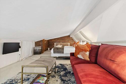 a living room with a couch and a bed at Chic 1-BR Loft Nestled Between Dupont & Logan in Washington, D.C.