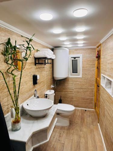 a bathroom with a sink and a toilet at Paris Hotel Cairo in Cairo