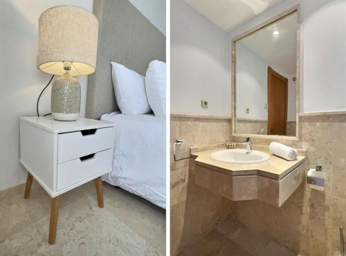 a bathroom with a sink and a mirror next to a bed at Gorgeous 3-Bedroom Penthouse with Expansive Terrace in Casares Costa in Buenas Noches