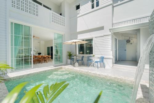 a villa with a swimming pool and a house at Seven Heaven Patong Villa in Patong Beach