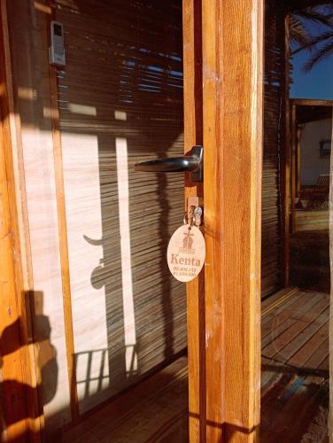 a wooden door with a lock on it at Garden12 Outdoor & More in Douz