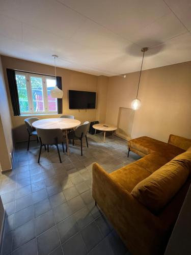 a living room with a couch and a table at Byhuset - Haven 10 in Vejle