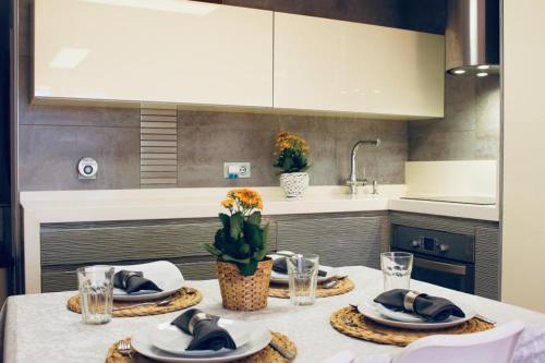 a kitchen with a table with plates and dishes on it at Sol y Brisa Resort Almerimar in Almerimar