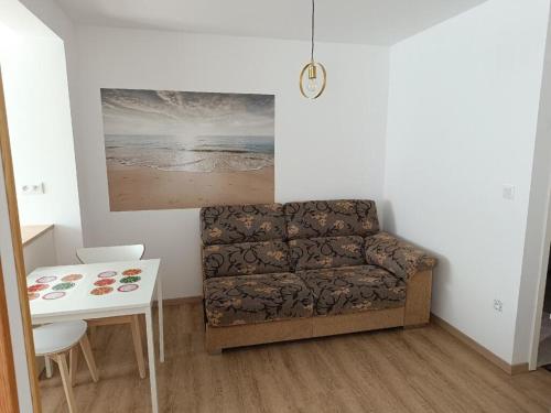 a living room with a couch and a table at La Pause in Soultz-Haut-Rhin