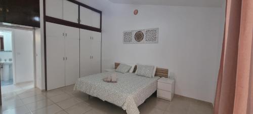 a bedroom with a bed with two candles on it at Bungalow en Las Américas in Playa de las Americas