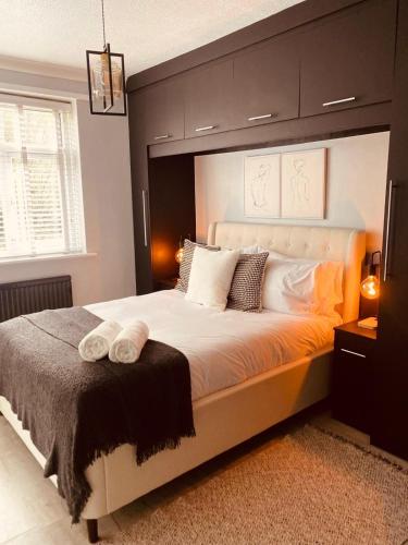 a bedroom with a large bed with a large headboard at The Secret Garden Retreat With Hot Tub in Manchester