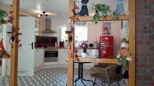 a kitchen with white cabinets and a red refrigerator at Wald-Elfe in Buchholz Aller
