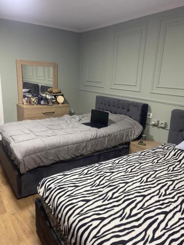 a bedroom with two beds with a laptop on top at Sweet Home villa in Tirana