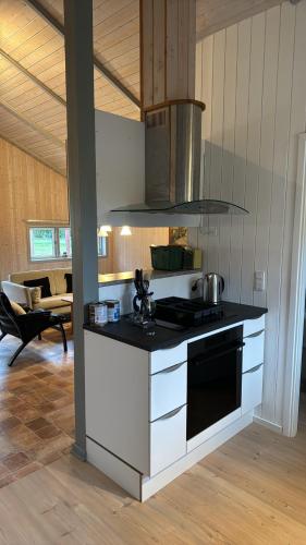 a kitchen with a black and white stove top oven at Langø Feriecenter - Panorama Sea View in Nakskov
