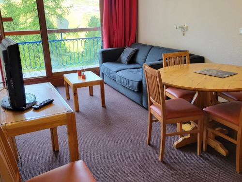 un salon avec un canapé et une table dans l'établissement Studio cabine proche centre station avec balcon, WiFi gratuit - FR-1-346-423, à Arc 1800