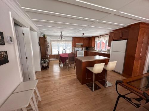 a kitchen and living room with a table and chairs at Domaine Gagnon in Saint Sebastien