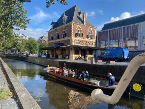 a group of people in a boat on a river at Elegant appartement in Pakhuis Friesland centrum in Leeuwarden