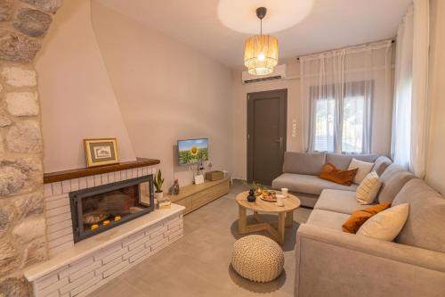 a living room with a couch and a fireplace at Relax house by the sea in Volos