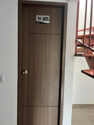 a wooden door with a sign on it at Quinta Las Mendoza in Zetaquira