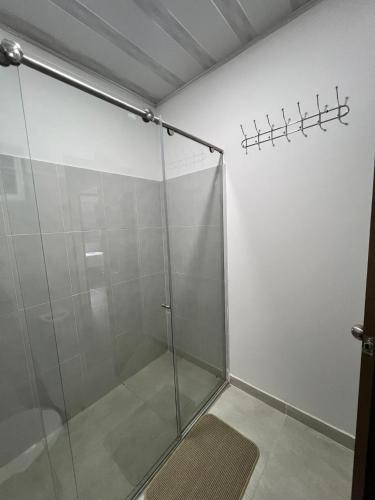 a shower with a glass door in a bathroom at Quinta Las Mendoza in Zetaquira