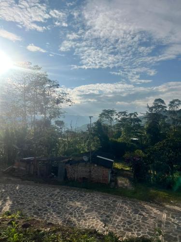a house on a hill with the sun in the sky at Quinta Las Mendoza in Zetaquira