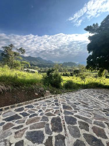 a stone walkway with a view of a field at Quinta Las Mendoza in Zetaquira