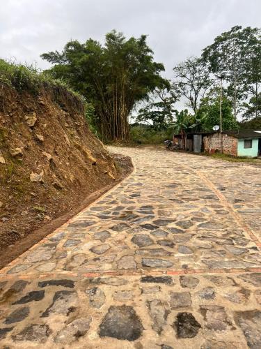 a cobblestone road with trees on the side of a hill at Quinta Las Mendoza in Zetaquira