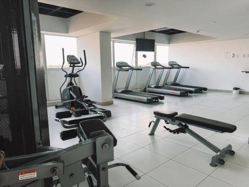 a gym with several treadmills and elliptical machines at Silverton Paiva Experience in Recife