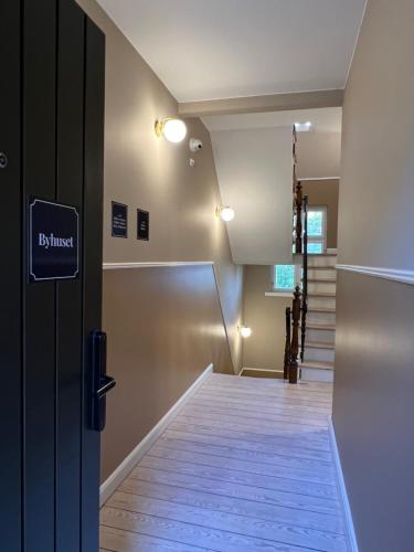 a hallway with a door and stairs in a building at Byhuset Vejle in Vejle