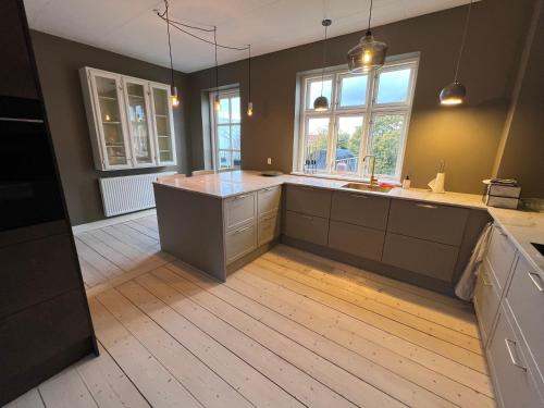 a kitchen with a large island in the middle at Byhuset Vejle in Vejle