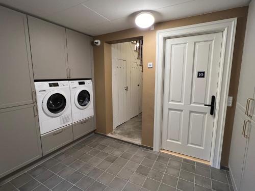 a laundry room with a washer and dryer at Byhuset Vejle in Vejle
