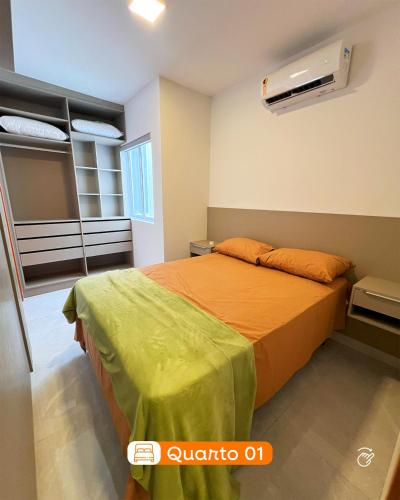 a bedroom with a bed with an orange bedspread at 01 - Saint Marie Beach House in Conde