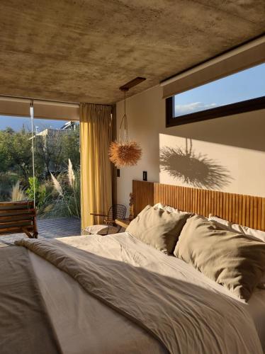 a bedroom with a large bed and a large window at La Singladura in La Población