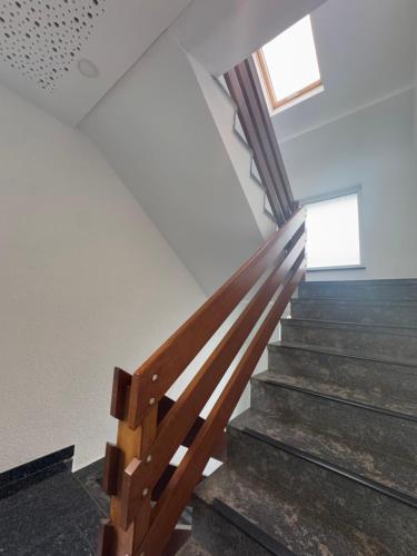 a staircase in a house with a wooden railing at Hotel Hildesheimer Hof in Harsum