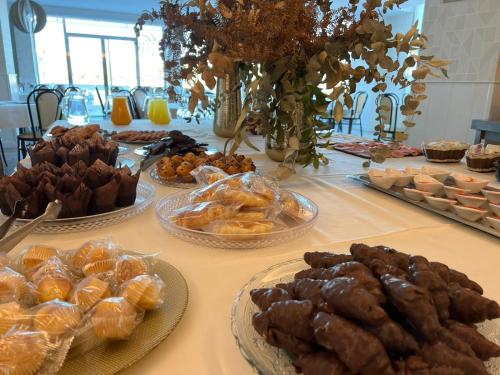 a table topped with plates of pastries and desserts at Hotel Restaurante Boabdil in Otura