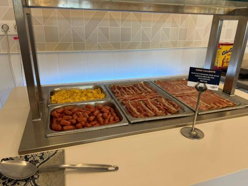a display case with many different types of food at Hotel Restaurante Boabdil in Otura