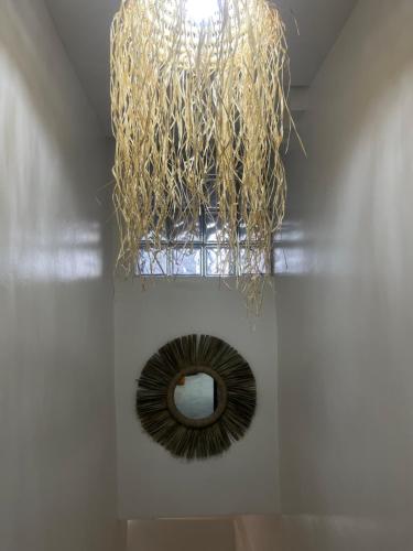 a chandelier hanging from a ceiling with a mirror at Sweet Taghazout Studios in Taghazout