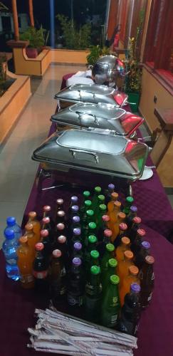 a row of bottles lined up on a table at Juniper Park Resort in Nyahururu