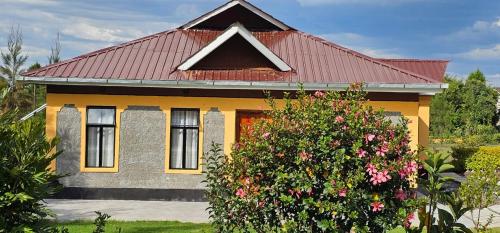 a yellow house with a red roof at Juniper Park Resort in Nyahururu