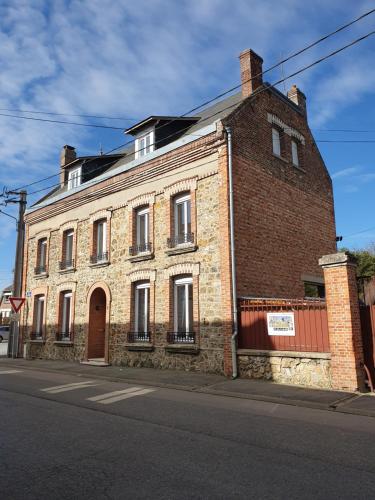 an old brick building on the side of a street at chez Marie et Patrick in Chaulnes